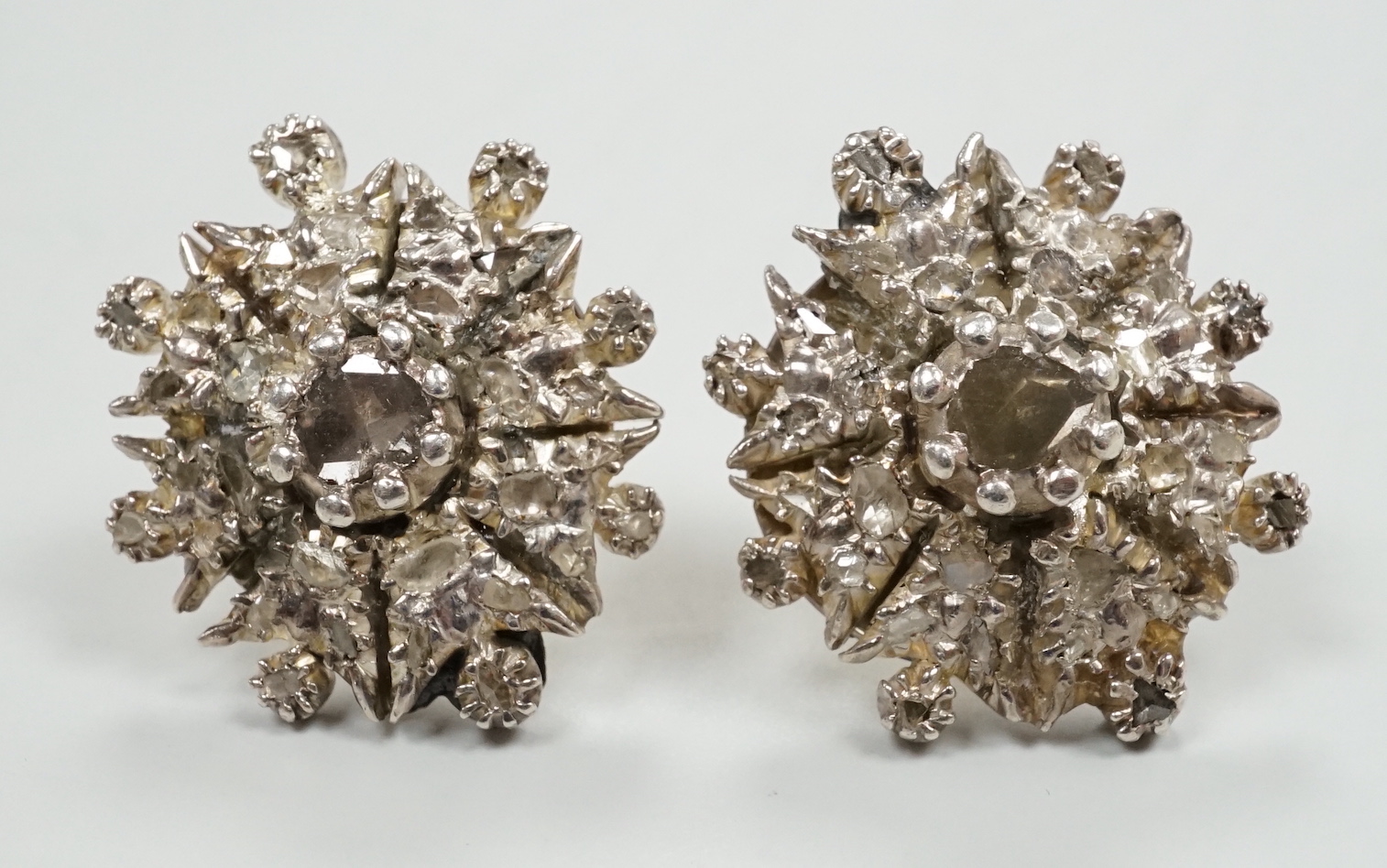 A pair of yellow and white metal, rose cut diamond cluster set earrings (lacking butterflies), diameter 21mm, gross weight 13.4 grams (adapted?).